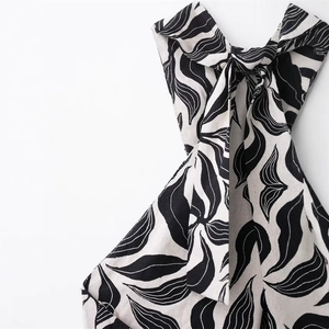 Halter neck maxi dress in linen blend featuring black and white abstract leaf print and bow