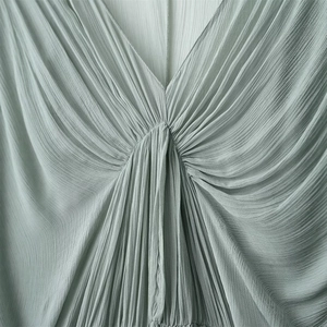 Sage green pleated maxi dress with elegant deep V-neckline and fine vertical drapery