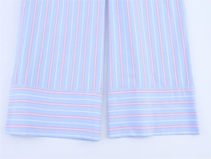 Detail shot of the striped fabric hem showing precise stitching on blue and pink stripes