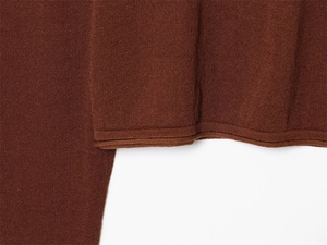Detailed close-up showing the premium hem stitching on dark brown linen knit sweater