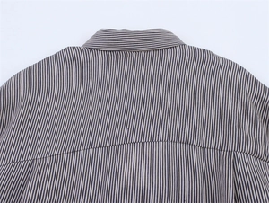 Close-up of fine vertical blue stripes and horizontal collar stitching on linen shirt