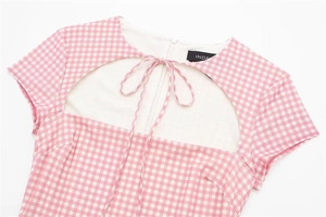 Detail of pink gingham dress with a hollow neckline and lace-up bow tie decoration