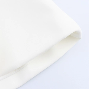 Detailed macro view of high-quality white knitted fabric cuffs and hem stitching texture