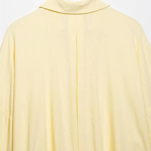 Pale yellow linen-blend long sleeve shirt for women featuring a pleated back detail