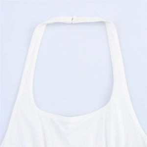 Detail view of white halter top neckline featuring dual button closure and precise stitching