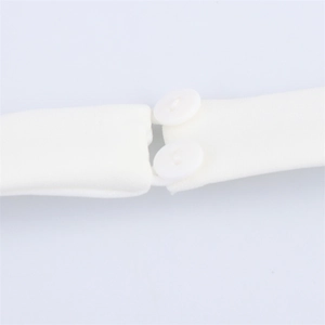 Close-up of white chiffon fabric with two round buttons and elastic loop fasteners