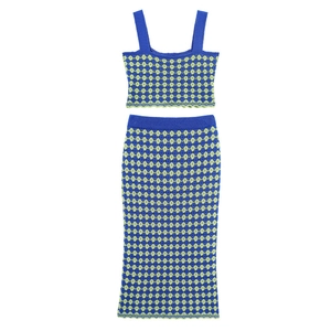 Detail of blue and green checkered knit texture on matching crop top and midi skirt set