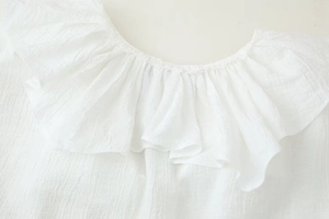 Close-up of elegant V-neckline with ruffled layers and crinkle texture on white chiffon blouse