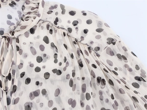 Detail of ruffled stand collar with drawstring and artistic dot print chiffon fabric