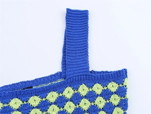 Detail of blue and lime green crochet knit top showing intricate diamond hollow pattern