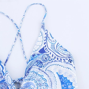 Close-up of blue paisley floral pattern on a bohemian cotton halter maxi dress