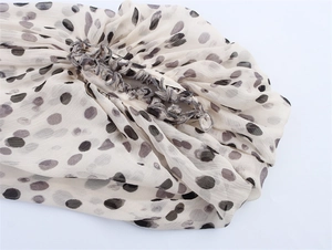 Close-up of leopard print chiffon fabric with elastic pleated edge and delicate stitching