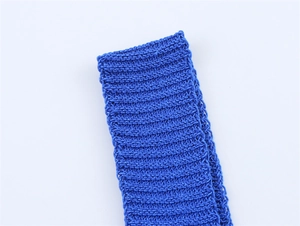 Macro detail of royal blue knit fabric featuring premium ribbed texture and elastic weave