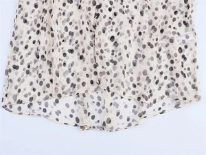 Detailed view of lightweight animal print chiffon shirt with buttons and curved hem