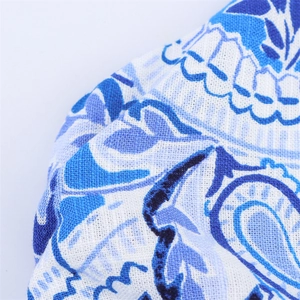 Detailed macro view of the breathable blue ethnic textured cotton-linen fabric dress