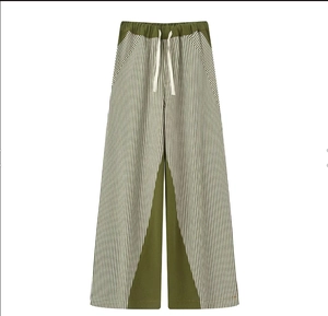 Detail view of the drawstring elastic waistband on green and striped wide leg pants