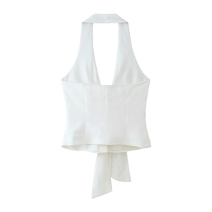 Detail of white halter neck top with textured fabric and stylish self-tie waist design