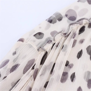 Women's animal print chiffon shirt featuring delicate ruffle details and grey rolled hem
