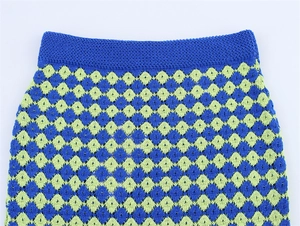 Detail of blue and green checkered crochet knit set showing waist texture and pattern