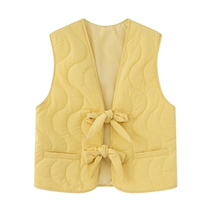 Quilted sleeveless vest for girls in soft yellow featuring stylish front bow closures