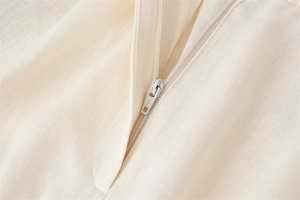 Close-up of the beige linen fabric texture and high-quality matching zipper detail