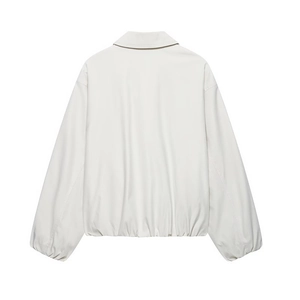 Back view of minimalist ivory bomber jacket with drop shoulders and elasticated hem