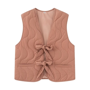 Dusty pink quilted V-neck sleeveless vest featuring wavy patterns and bow tie closures