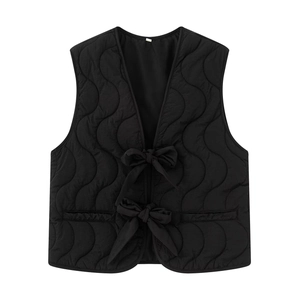 Women's black quilted vest featuring unique wave stitching and front bow ribbon ties