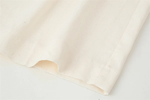 Macro shot of off-white cotton linen fabric texture and neat hemline stitching detail