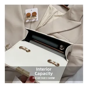 Detailed view showing internal capacity of the white quilted chain bag with gold hardware