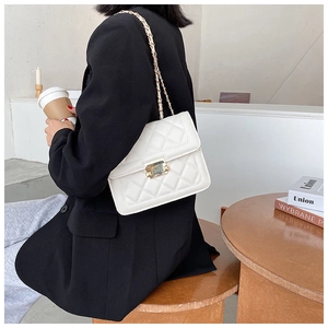 Detailed back view of a white quilted chain crossbody bag with elegant gold hardware
