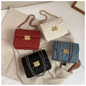 Detail of quilted leather crossbody bags with golden chain straps in multiple colors
