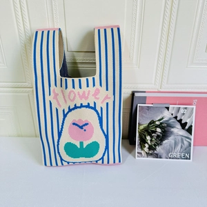 Detailed macro view of the knitted tote bag with pink tulip design and flower embroidery