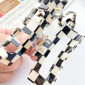 Large checkerboard claw clip in black and cream resin with strong gold metal spring