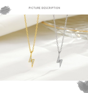 Macro detail of lightning bolt pendants in gold and silver with crystal pavé
