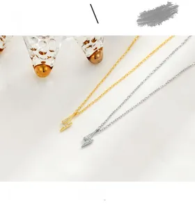 Close-up of gold and silver S925 sterling silver lightning bolt necklaces with CZ stones