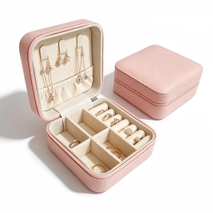 Pink portable jewelry box with PU leather finish showing internal rings and necklace slots