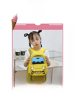 Toddler backpack with yellow cartoon car design worn by a child in outdoor setting