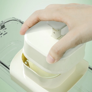 Manual cream white vegetable slicer and food dicer with a clear collection container