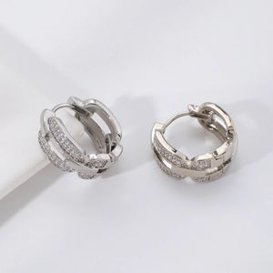 Macro detail of silver-tone hoop earrings with pave set cubic zirconia stones