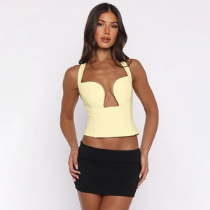 Detail of light yellow deep U-neck cutout corset top with sleek black mini skirt