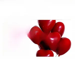 Detail showing the thick, polished surface of red heart-shaped latex balloons for decor