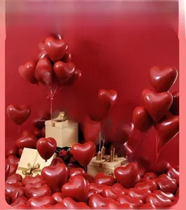 Deep red heart-shaped latex balloons with champagne ribbons for romantic wedding decor