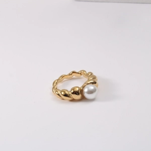 Detail of twisted rope texture and white pearl on 18k gold plated titanium ring