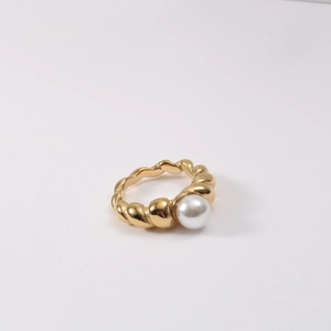 Close-up of twisted rope titanium steel ring with an 18k gold finish and a white pearl