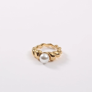 Macro shot of 18k gold plated twist band ring featuring a round white pearl detail