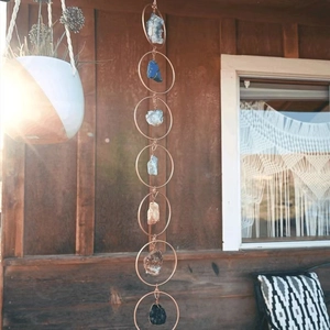 Vertical boho wall hanging with natural raw gemstones and copper metal rings décor