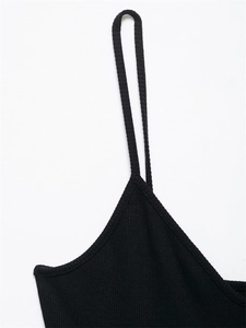 Close-up of black ribbed knit midi dress fabric with thin straps and neat stitching