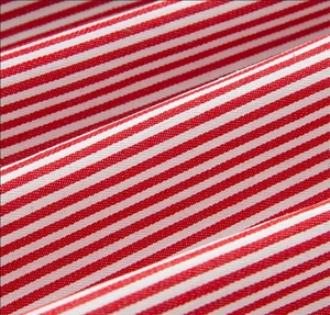 Detailed macro view showing the red and white striped texture of the wide-leg pants fabric