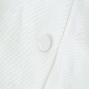 Macro shot of white twill fabric texture and matching fabric-covered button detail